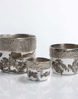 Set of three silver and white ceramic pots on a light gray background