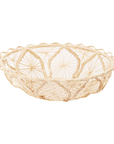 Woven bread basket with decorative pattern on a white background