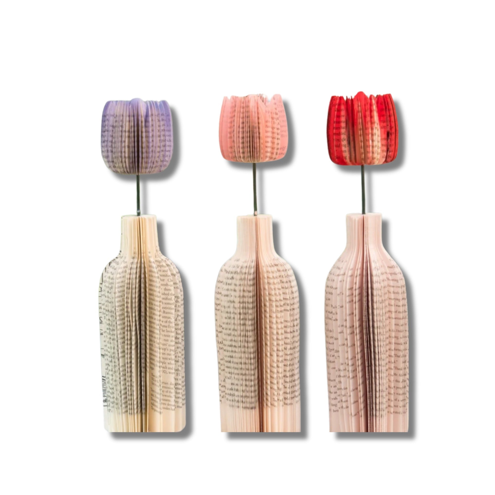 Three decorative tulip-shaped vases made of repurposed book pages with colorful tops on a white background