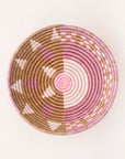 Woven basket with pink and brown pattern on a white background