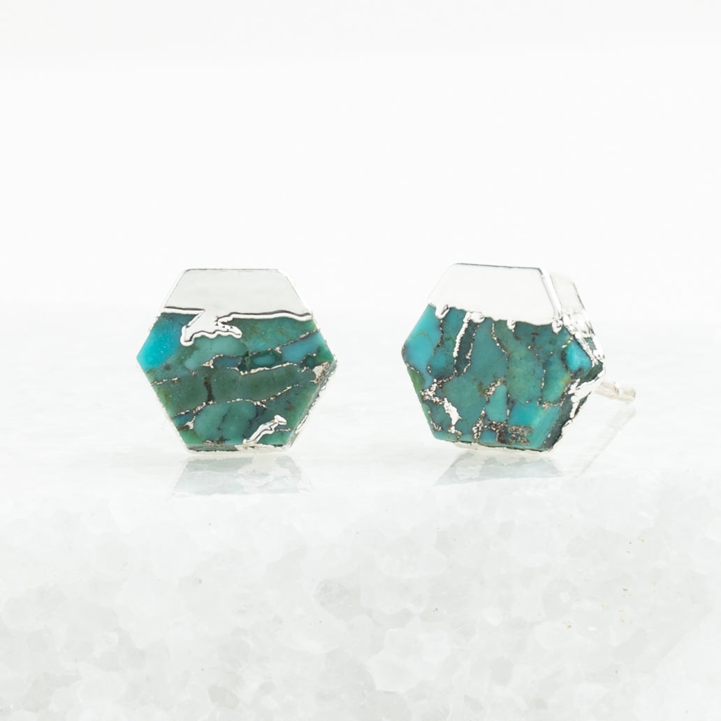 Hexagonal turquoise earrings on a clear background
