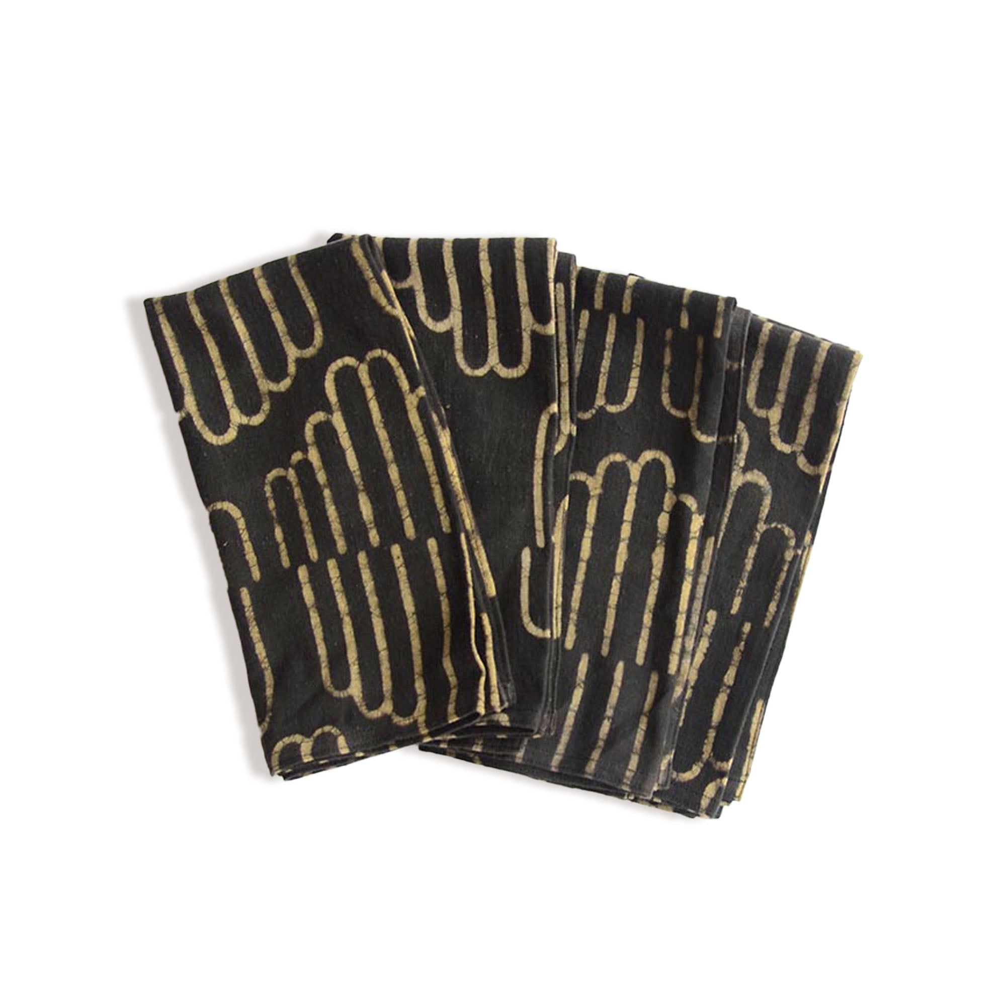Set of black napkins with gold geometric pattern on a white background