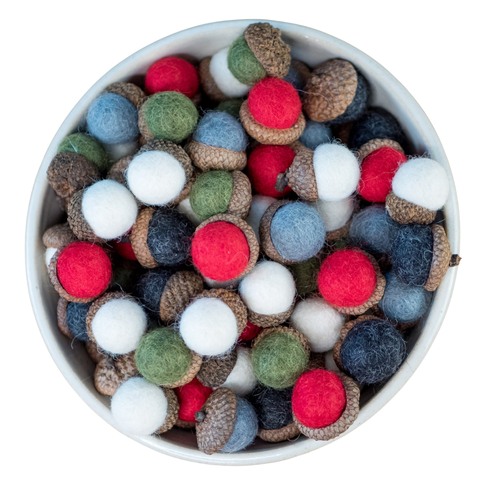 Colorful felt acorn ornaments in a white bowl on a white background