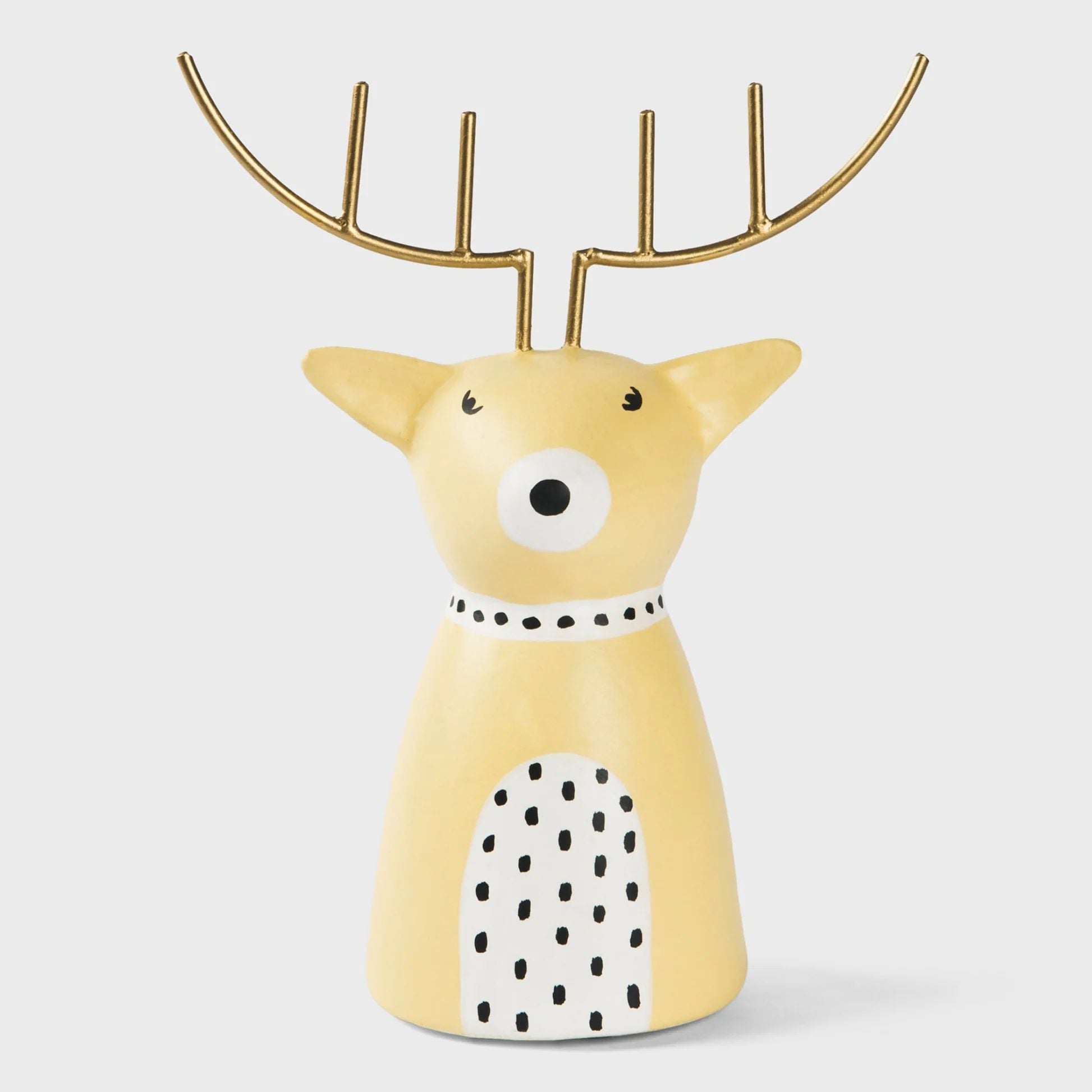 Decorative yellow reindeer figurine with gold antlers on a light gray background