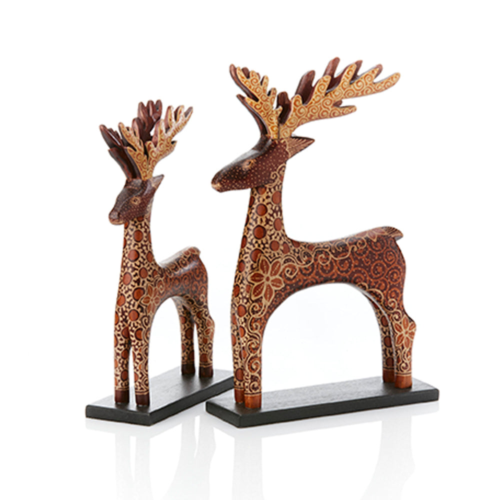 Decorative deer statues with intricate patterns on a white background