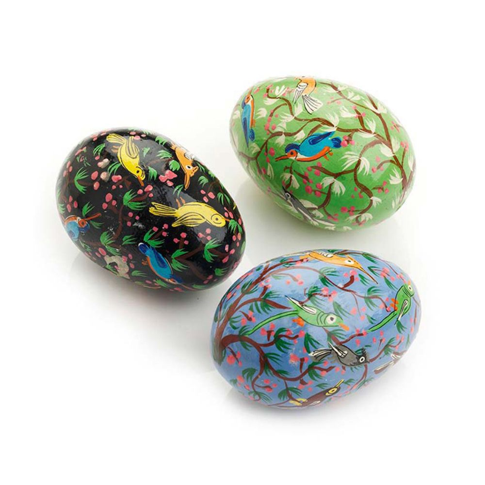 Three painted easter eggs with bird designs on a white background