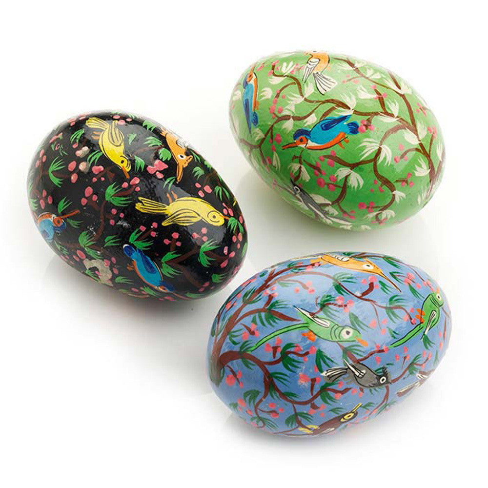 Three painted easter eggs with bird designs on a white background