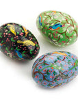 Three painted easter eggs with bird designs on a white background