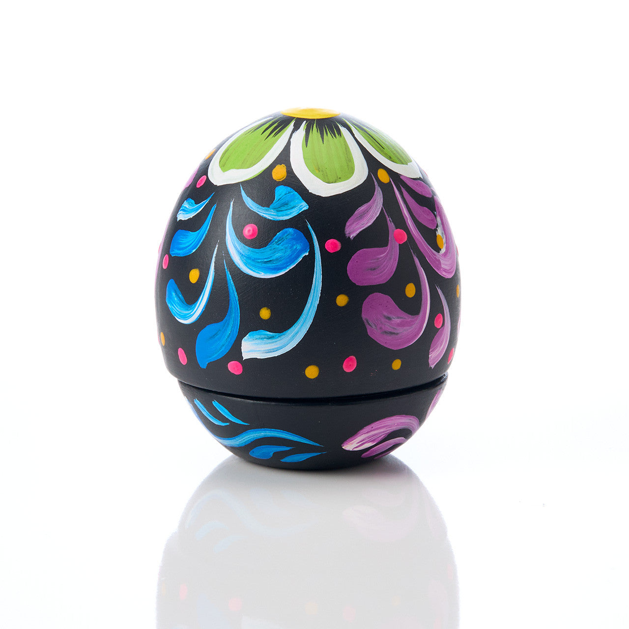 Colorful ceramic easter egg with floral patterns on a white background