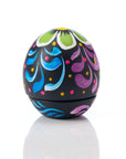 Colorful ceramic easter egg with floral patterns on a white background