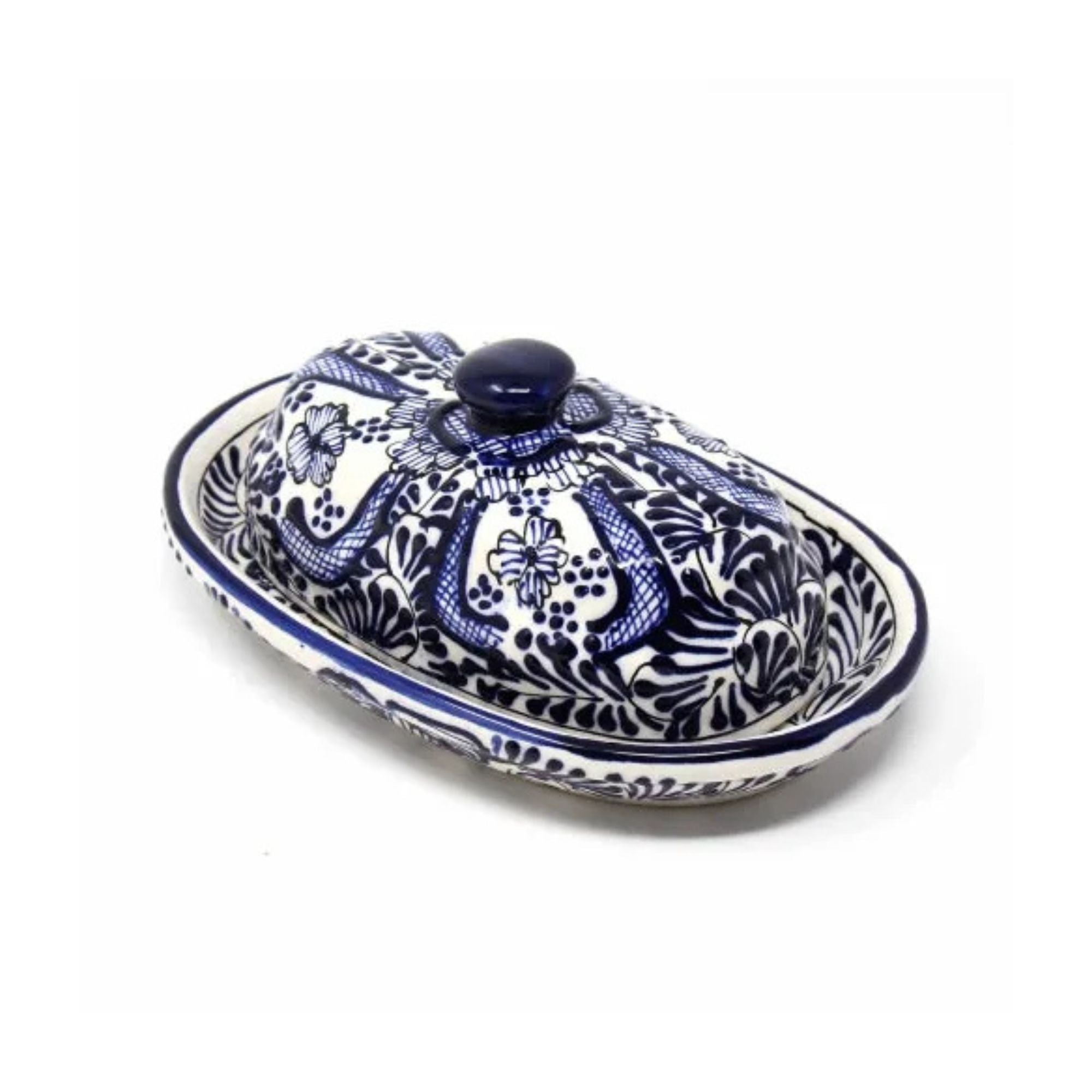 An oval ceramic butter dish with a matching lid, decorated with a blue and white floral pattern, shown on a plain white background.