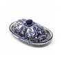 An oval ceramic butter dish with a matching lid, decorated with a blue and white floral pattern, shown on a plain white background.