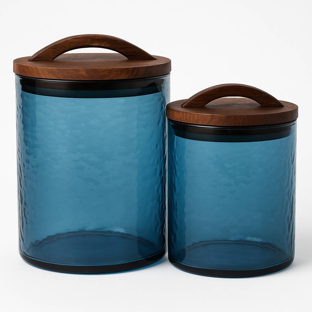 Two blue glass canisters with wooden lids on a white background
