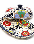 Decorative ceramic butter dish with lid featuring colorful floral patterns on a white background