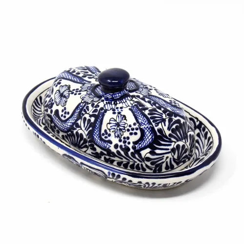 Ceramic butter dish with blue and white floral design pattern on a white background