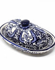Ceramic butter dish with blue and white floral design pattern on a white background
