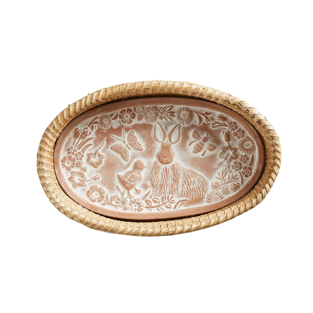 Decorative bread warmer and stone with animal and floral design on a white background