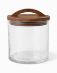 Clear glass jar with a wooden lid on a white background