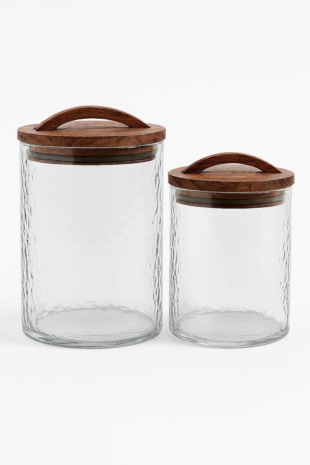 Two glass canisters with wooden lids on a white background