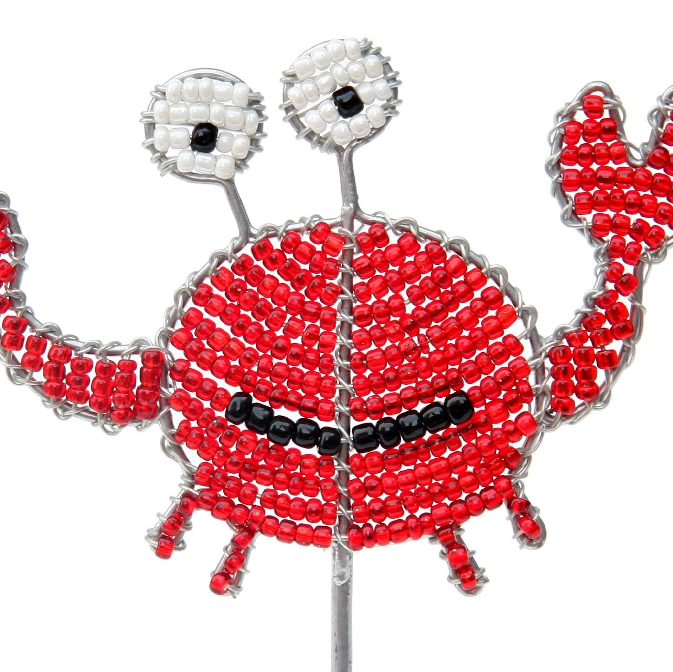 Decorative crab stake made of red beads on a white background