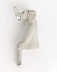 Decorative elephant shelf sitter on a white background