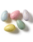Five speckled Easter eggs in pastel colors on a white background
