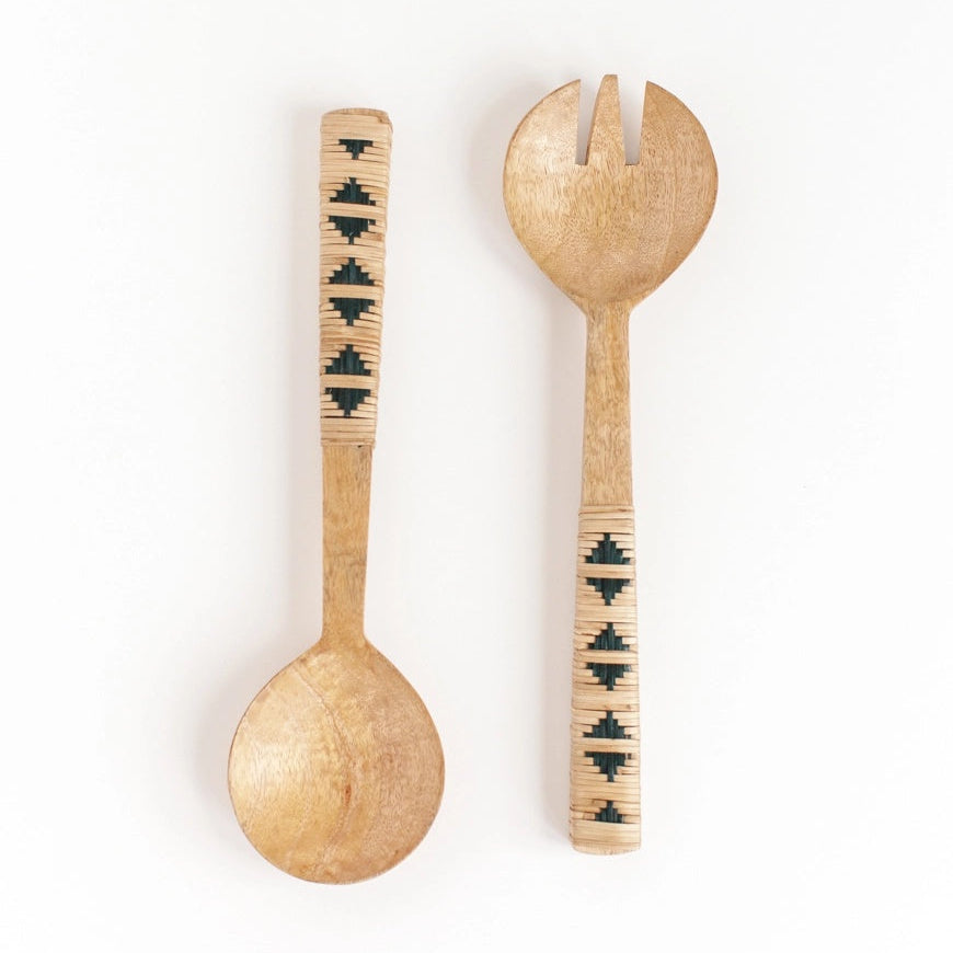Wooden set of salad servers with decorative handles on a white background