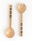 Wooden set of salad servers with decorative handles on a white background