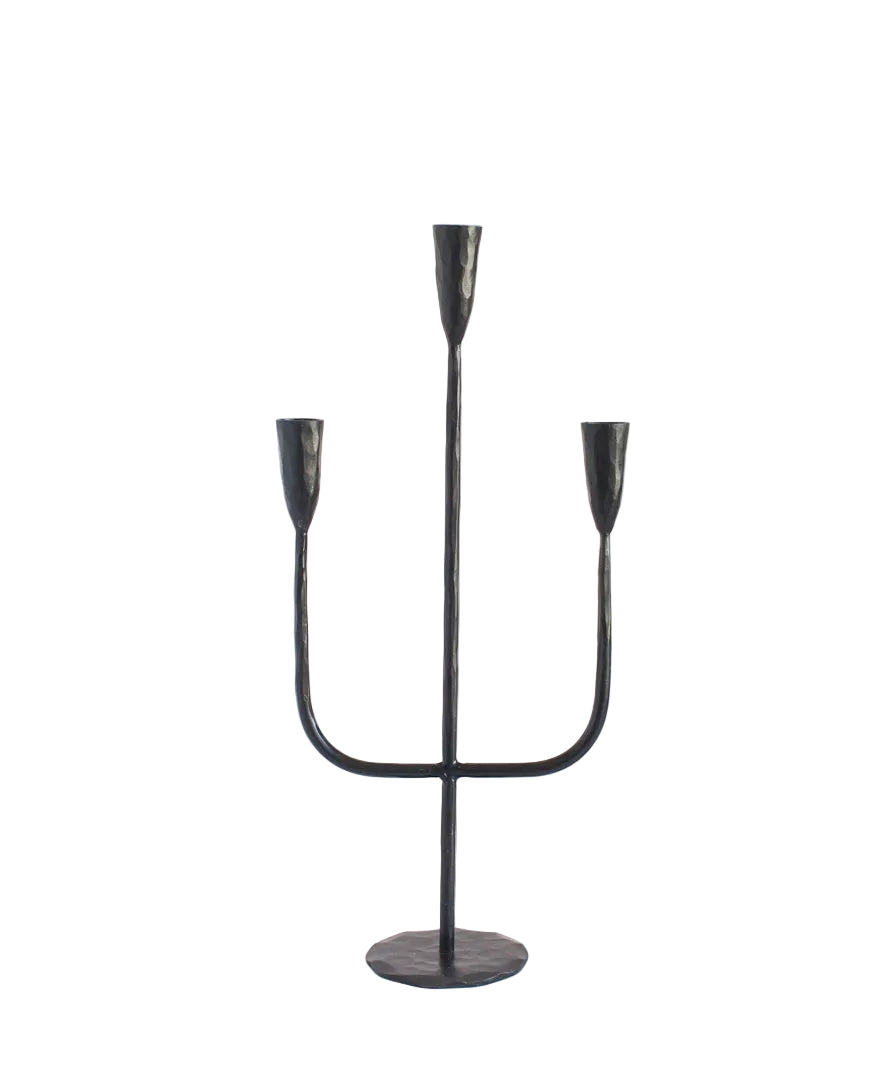 Black metal candelabra with three candle holders on a white background
