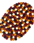 Round felt trivet with a pattern in autumn colors on a white background