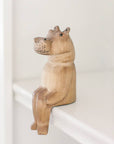 Hand painted wood hippo figurine sitting on a shelf