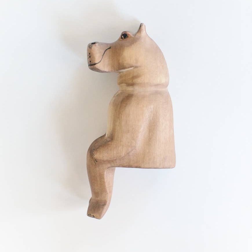 Wooden hippo figurine on a white background
