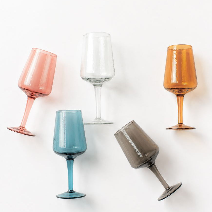 Set of colorful wine glasses on a white background