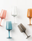 Set of colorful wine glasses on a white background