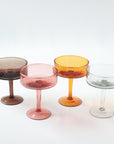 Four colorful cocktail glasses on a white background