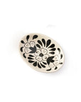 Round ceramic dish with black floral patterns on a white background