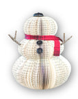 Large snowman made of repurposed paper and wooden arms displayed against a white background