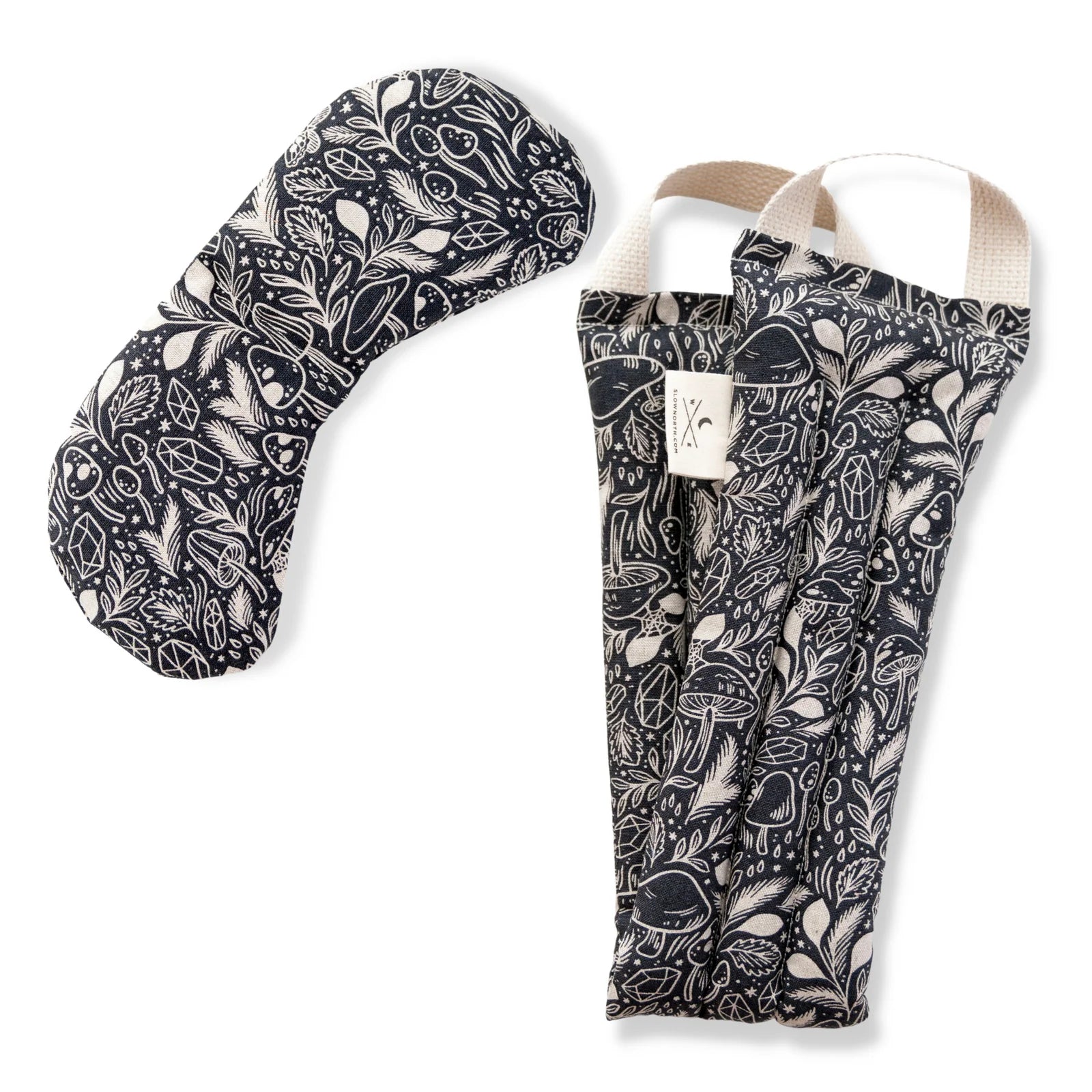 Black and white neck wrap and eye mask bundle on a white background