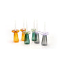Set of colorful glass candle holders with candles on a white background