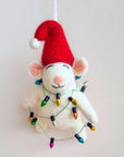 White mouse ornament with red Santa hat and string of lights on a plain background