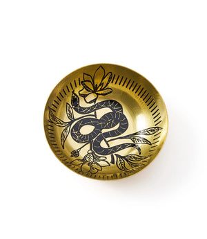Gold decorative plate with snake and lotus design on a white background