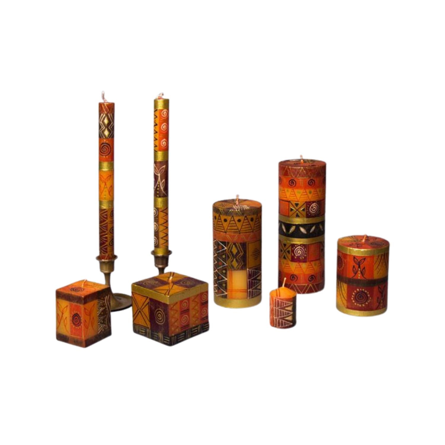 A set of decorative taper and pillar candles in earthy orange, brown, and gold tones with geometric tribal-style patterns, displayed on a plain white background.