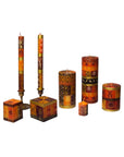 A set of decorative taper and pillar candles in earthy orange, brown, and gold tones with geometric tribal-style patterns, displayed on a plain white background.