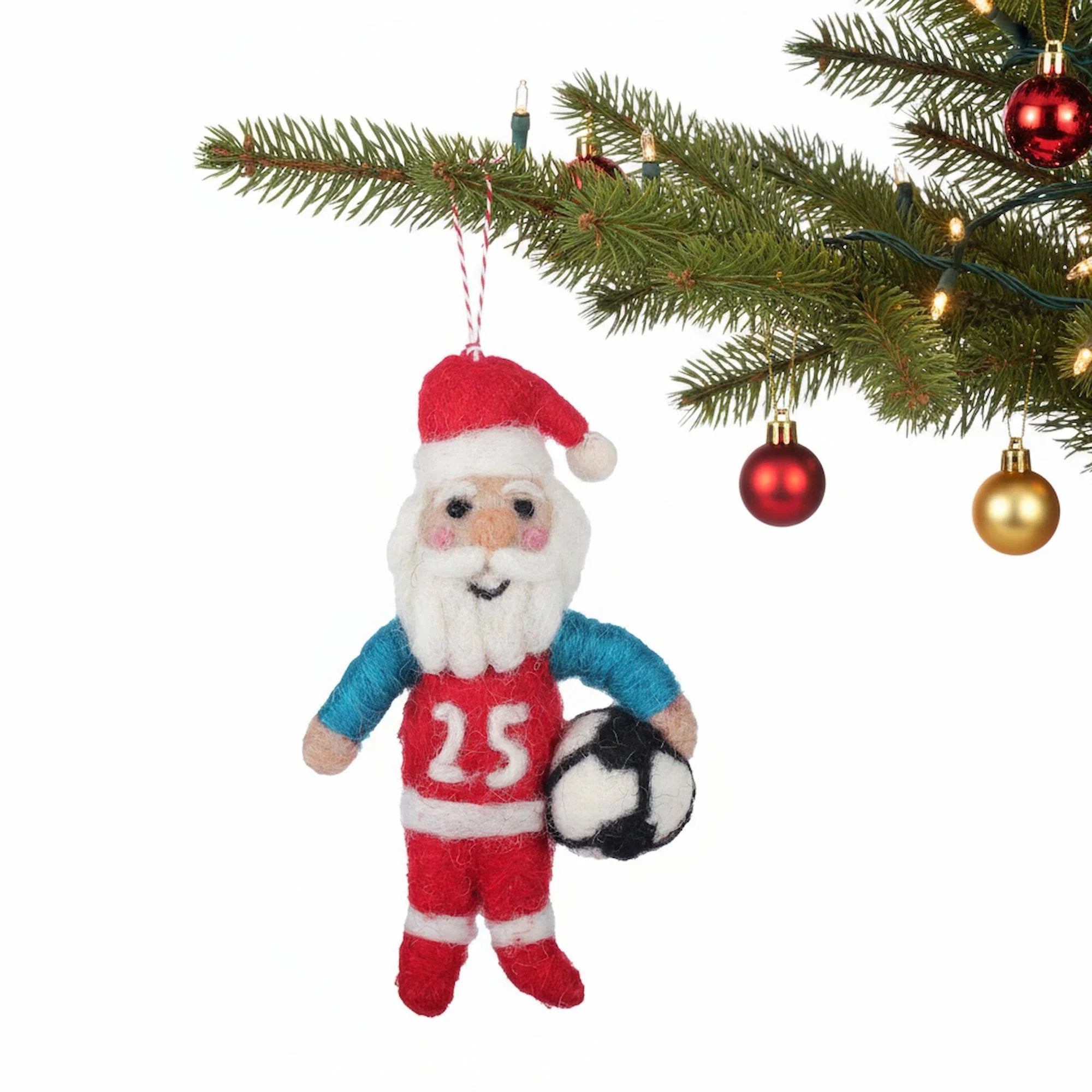 Decorative ornament of a soccer-themed Santa Claus hanging on a Christmas tree