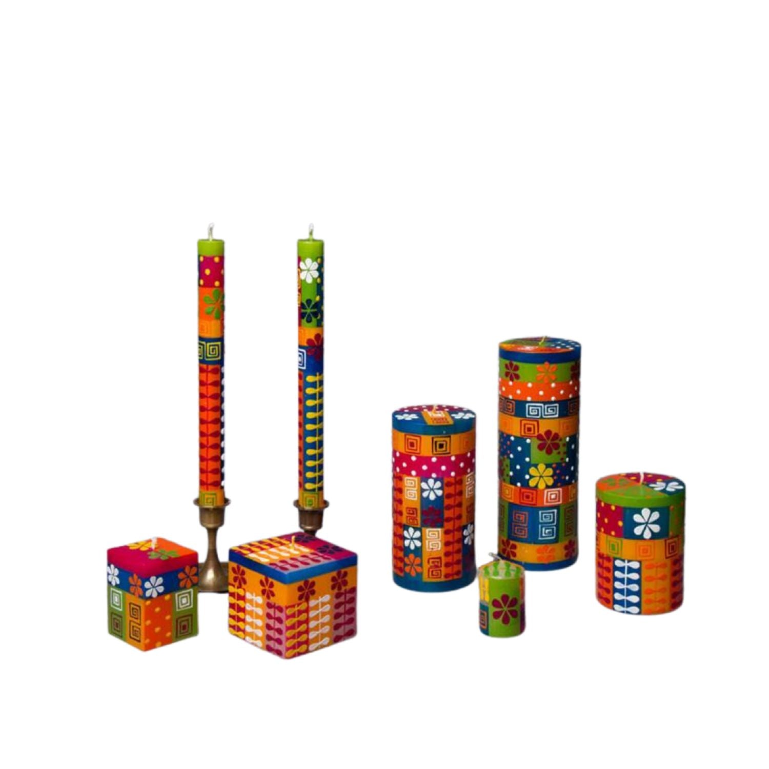 Colorful decorative candles and containers on a white background