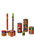 Colorful decorative candles and containers on a white background