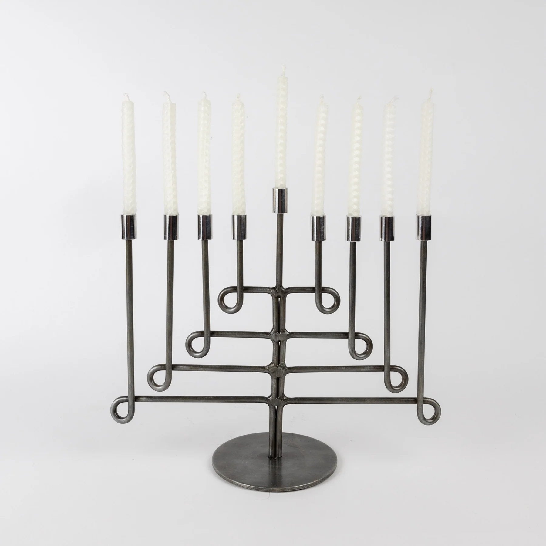 Iron twisted menorah with eight white candles