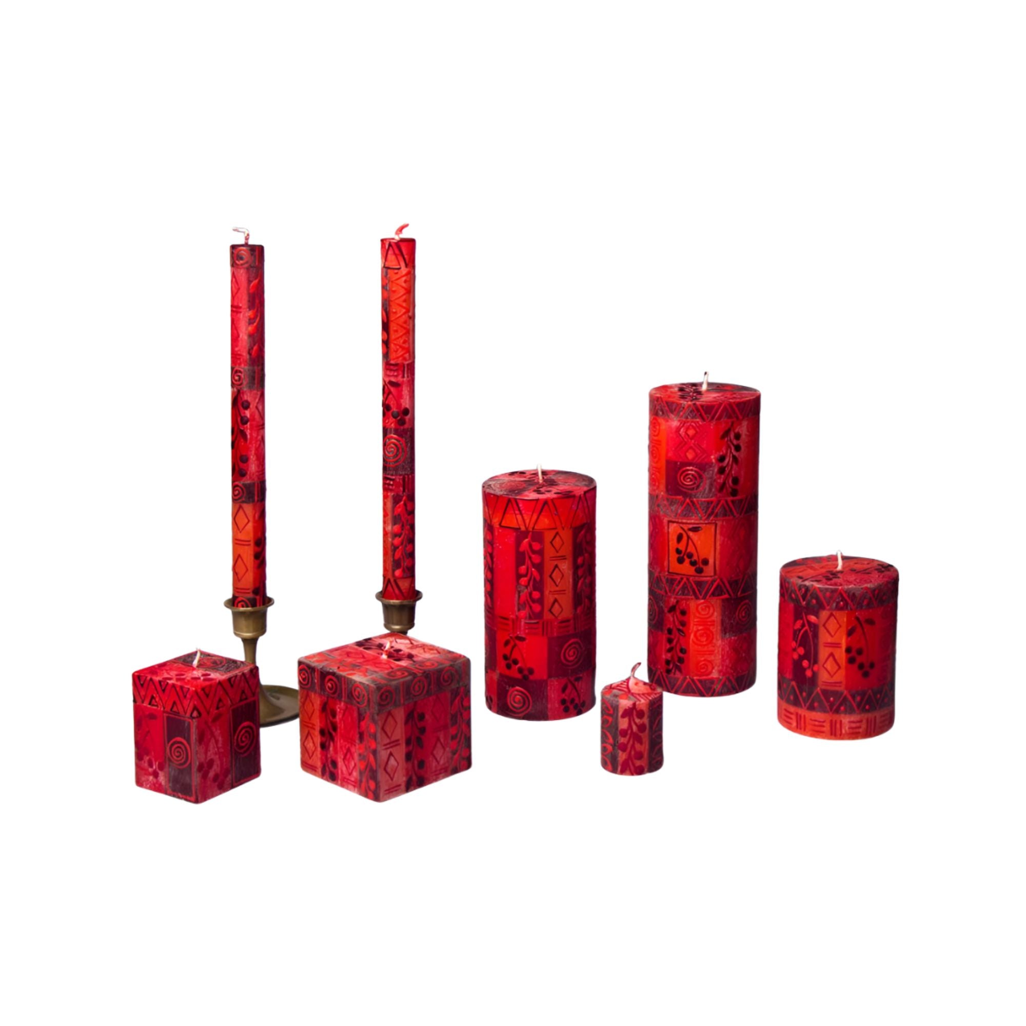Set of red patterned candles on a white background