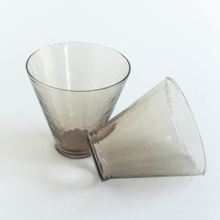 Two clear glass tumblers on a white background