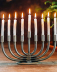 Menorah with lit candles on a wooden surface